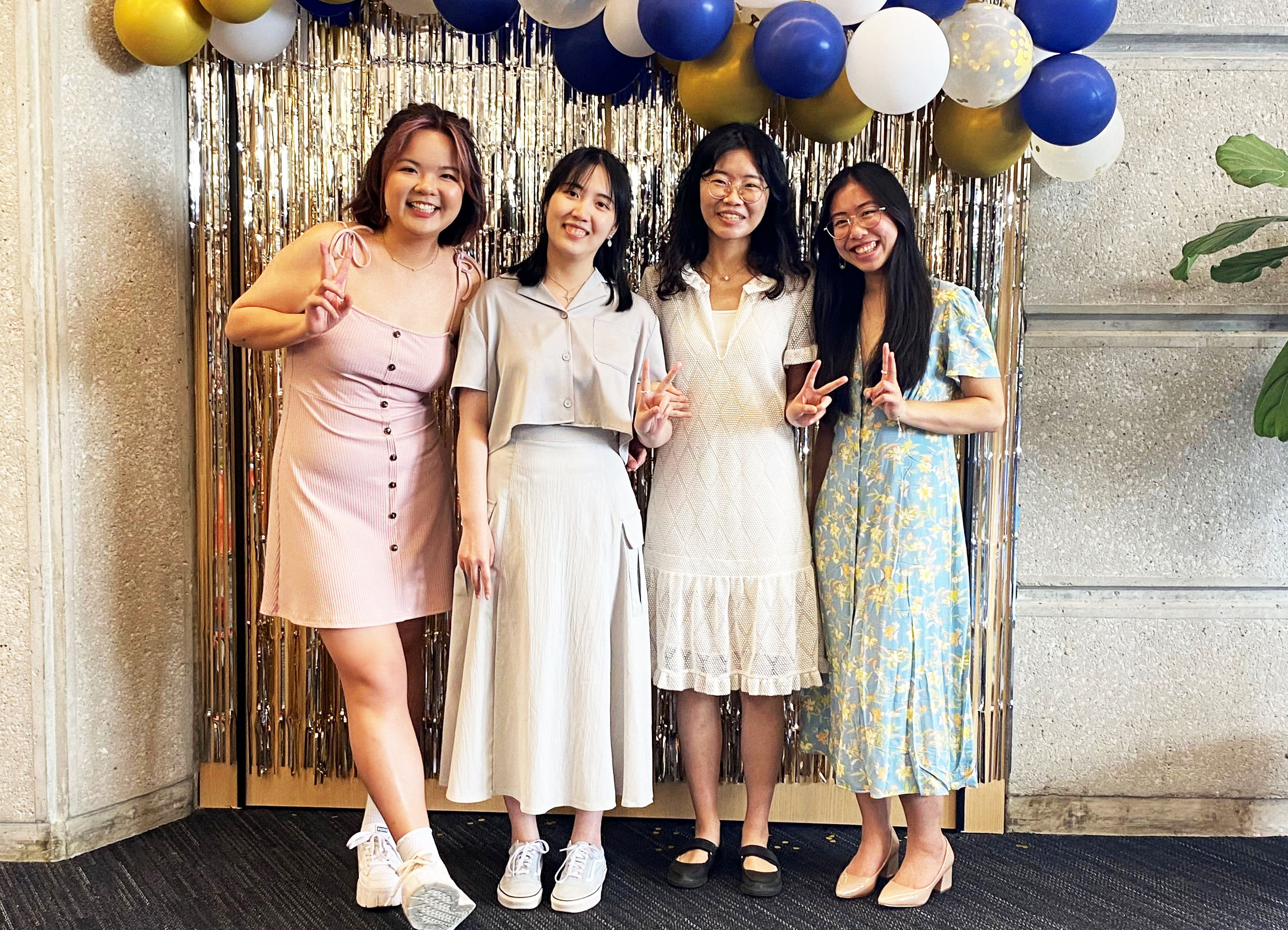 Siyun Pan, Tianyi Zhu, Yuan Zhou and Ashley Wong standing in front of balloons