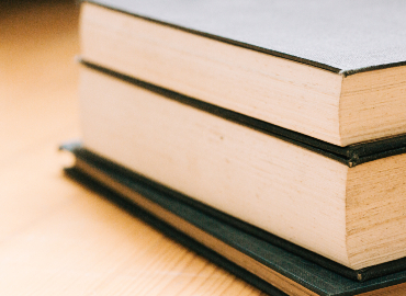 Three books stacked on top of each other.