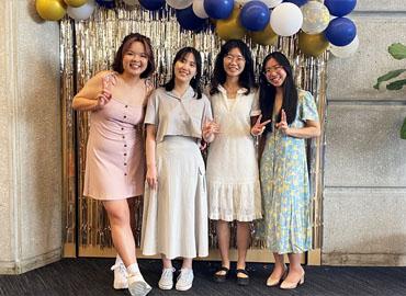 Siyun Pan, Tianyi Zhu, Yuan Zhou and Ashley Wong standing in front of balloons